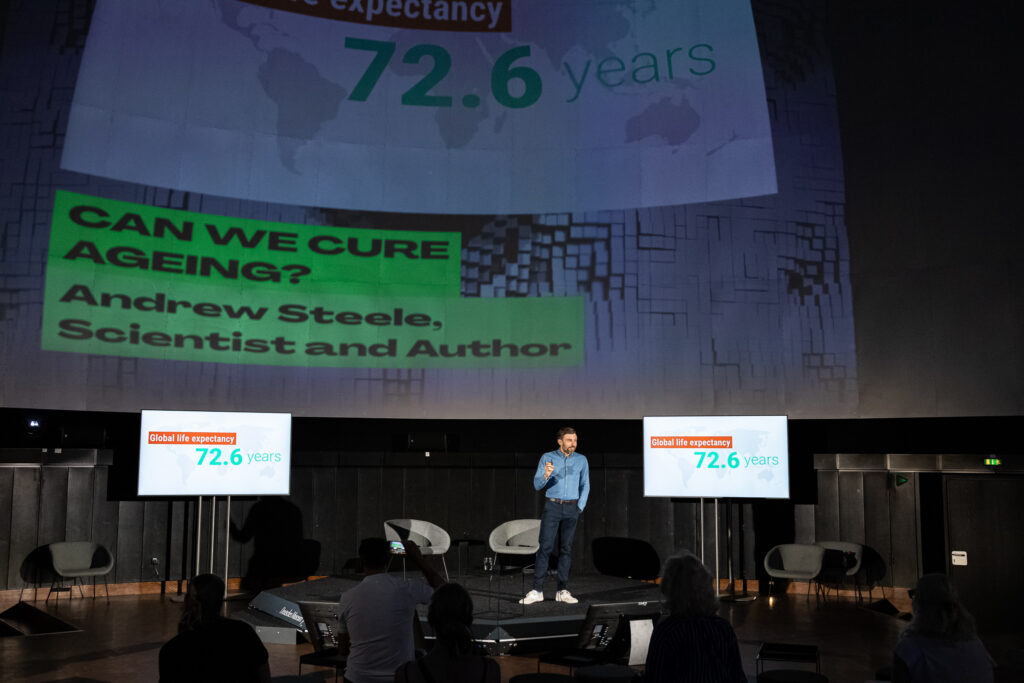 Andrew speaking in a planetarium in Munich, Germany
